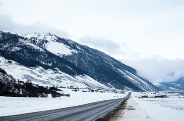 The road in the snow-capped mountains . Winter landscape. 
