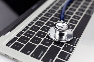 stethoscope on laptop keyboard.
