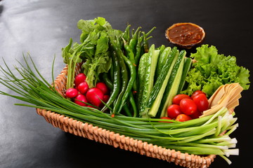 vegetables in basket on wooden table