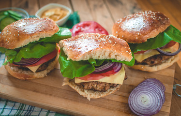 Close-up of homemade burgers on cutting board 