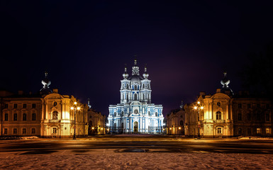 Fototapeta na wymiar Smolny Cathedral in baroque style under lantern light. Rastrelli Square, Saint Petersburg, Russia. Cityscape in deep winter night.