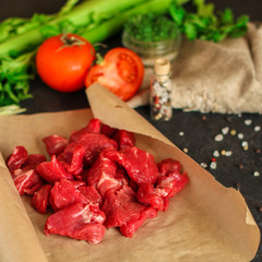 raw meat sliced, cut pieces on a cutting board, fresh. top view. food background