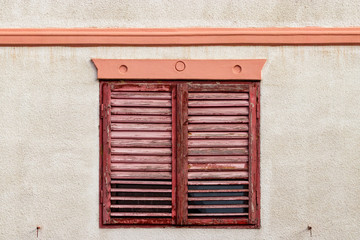 Red wooden blinds on house