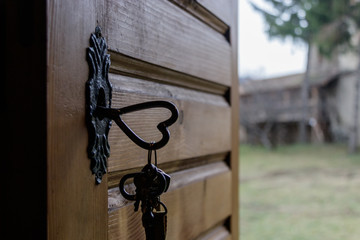 Heart shaped key in wooden door