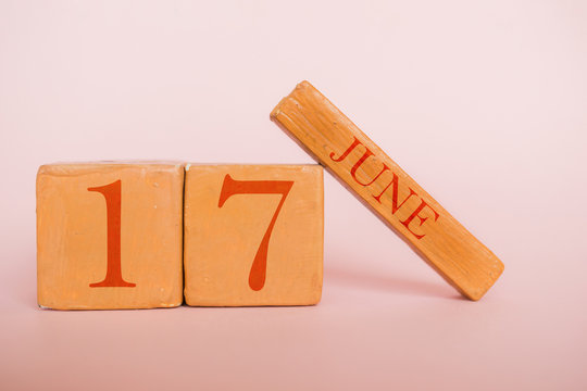 june 17th. Day 17 of month, handmade wood calendar  on modern color background. summer month, day of the year concept