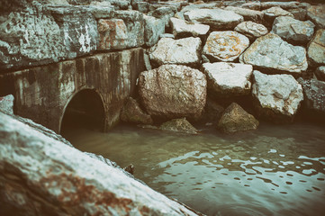 Old Concrete Drainage Pipe Discharges Into Water