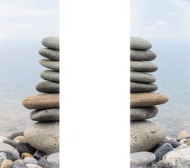 Pyramid of sea stones on pebbles of the sea shore. Seascape. The concept of balance and spirituality.