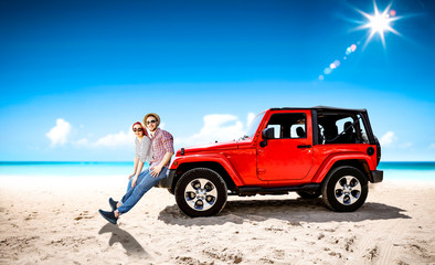 Fototapeta na wymiar Red summer car on beach and two lovers. Two people and summer background of beach. 