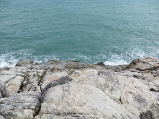 Fototapeta na wymiar Blue beach with big rocks