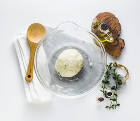 dough in a glass bowl on the table. home cooking food. healthy food