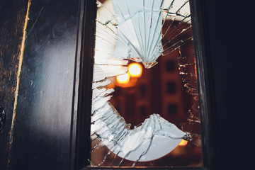 Broken glass black door of the shop.