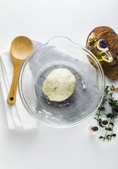 dough in a glass bowl on the table. home cooking food. healthy food
