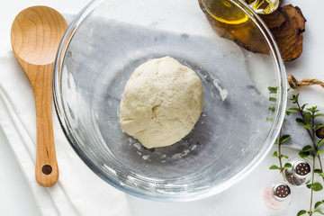 dough in a glass bowl on the table. home cooking food. healthy food