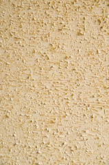 Old flaking yellow wall closeup