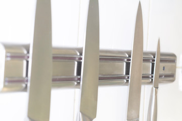 Professional kitchen knives on a special mount