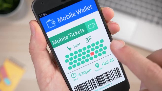 Mobile phone showing a virtual concert show ticket on its screen