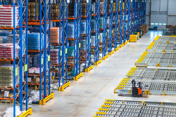 Distribution warehouse interior. Top view of large storage area with goods on the shelf and...