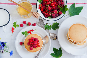 Breakfast Pancakes with fresh red berries and honey