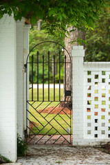 Iron Garden Patio Gate with a White Painted Brick Accent Wall Fence Outdoor Patio Curb Appeal