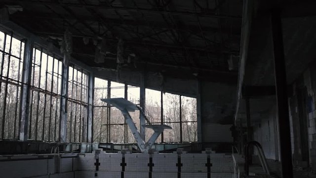 1080p video of the inside of an abandoned swimming pool, pan left in Chernobyl, Pripyat, The Ukraine