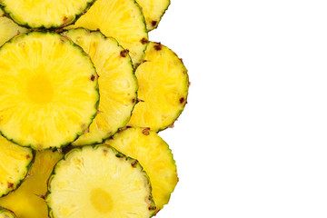 Pineapple juicy yellow slices background. Top view.