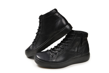 Men's black leather shoes and a black camera on a isolated on white background. Copy space.