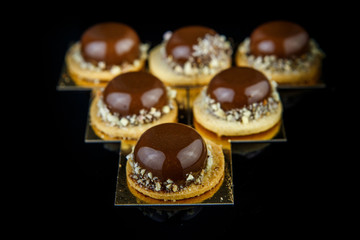 closeup top view of french mini mousse desserts served in triangle shape