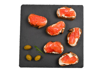 Salmon on a bread with cream isolated on white.