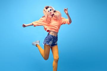 Young easy-going happy hipster Woman dance Having Fun in Stylish fashion headphones. Beautiful...