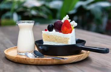 Sweet fruit cream cake cut serve.