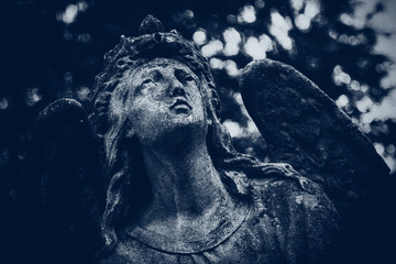 An ancient statue of the angel of death as a symbol of the messenger from heaven, takes life in person. Retro styled image.