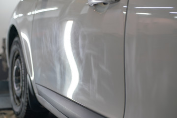Damage to the car paintwork, as a result of poor-quality washing. Scratches from the sand on the surface of the car. The car needs polishing