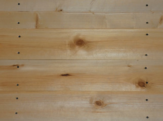 New wooden wall. Big fresh boards with knots. Natural background, wood texture. Horizontal structure.