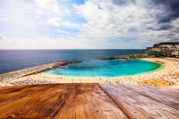 desk of free space and summer beach background 