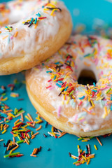 Donuts with scattering on a blue background close-up