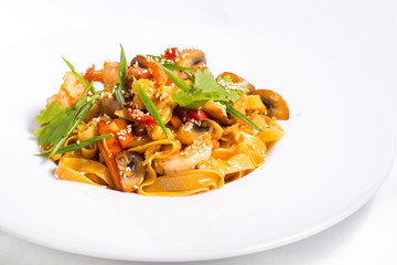 seafood and sesame pasta in a white plate