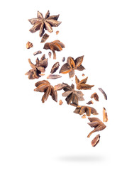 Crushed anise in the air close up, isolated on a white background