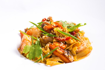 seafood and sesame pasta in a white plate