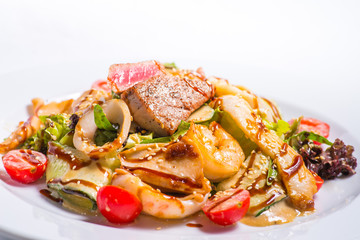 seafood salad with teriyaki sauce in a white plate