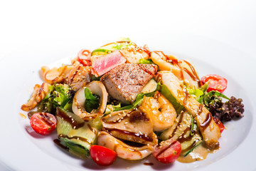 seafood salad with teriyaki sauce in a white plate
