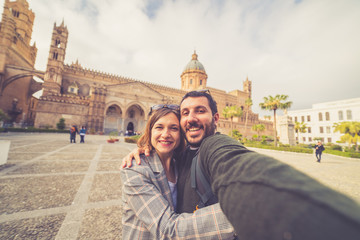 Fototapeta na wymiar happy tourist couple taking selfie in palermo, sicily, south of italy
