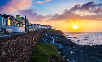 The town of Kilkee in Ireland and a beautiful sunset seen from the shore.