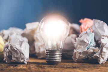 idea or light bulb with papers on the desk
