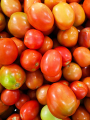 Tomatoes on shelves in supermarket, market.
