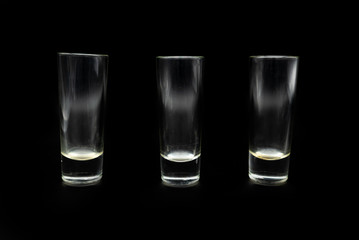 glass of whiskey on black background