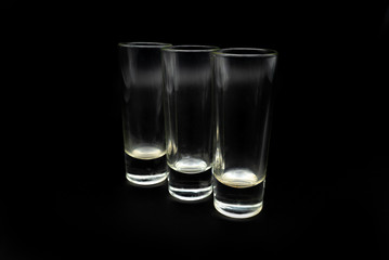 glass of whiskey on black background