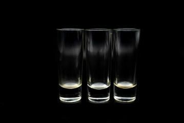 glass of whiskey on black background