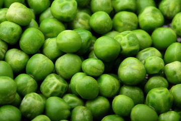 Fresh green peas background texture top view.Full depth focus.