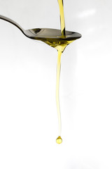 Oil being poured onto a spoon