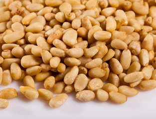 Pile of delicious pine nuts on a white surface